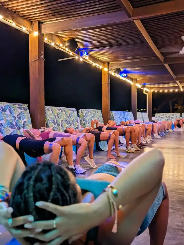 Bon Bini Booty class doing glute bridges with resistance bands