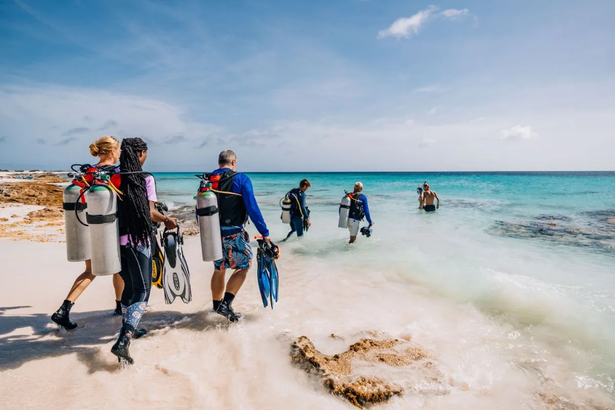 Divers walking into the sea for a shore dive